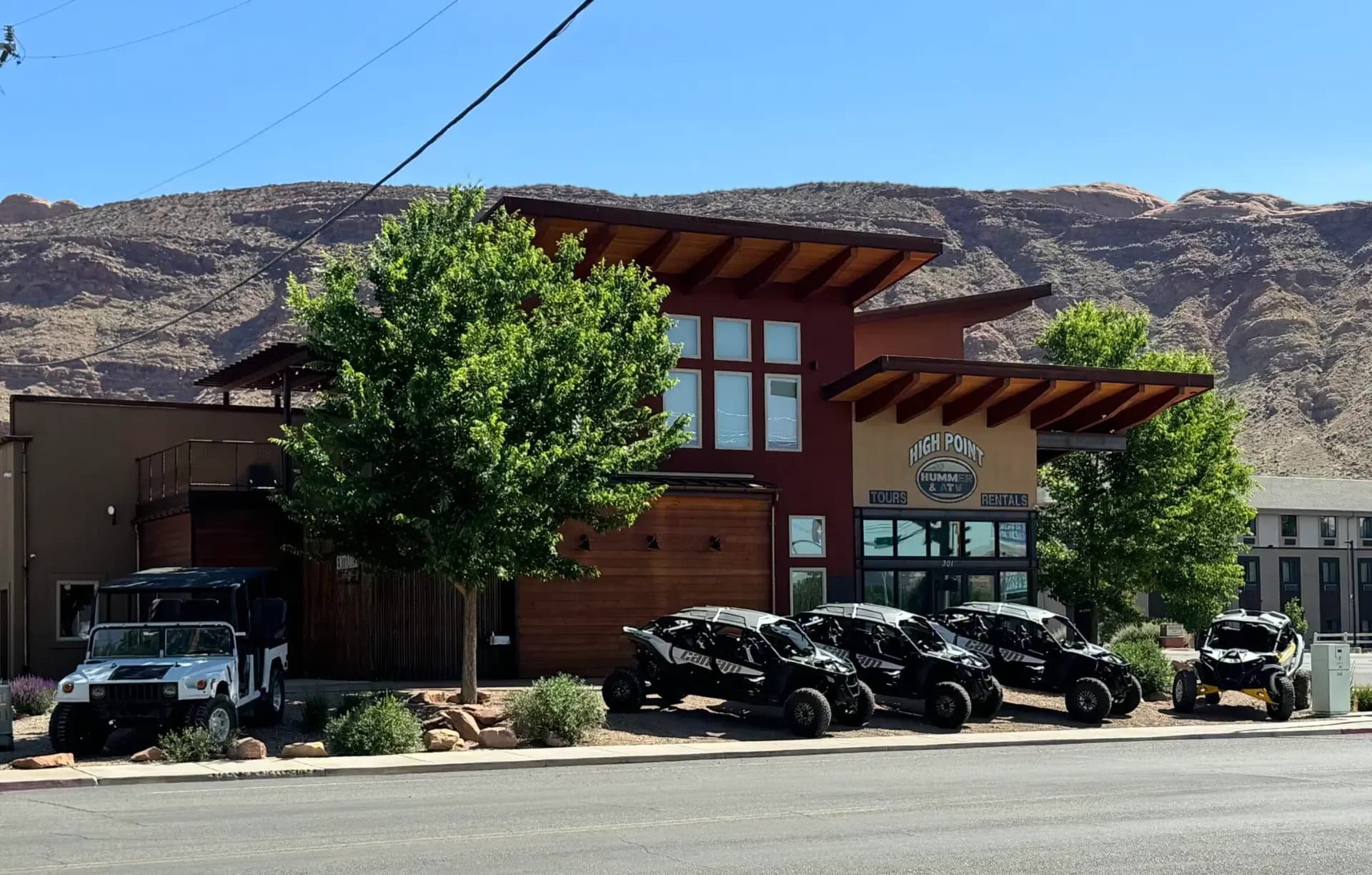 Street view of the High Point Hummer & ATV storefront in Moab with a Hummer and UTVs parked out front