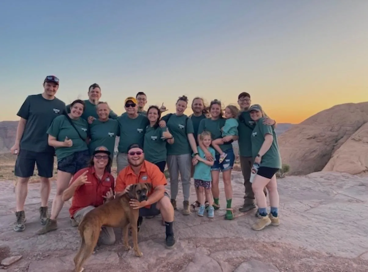 High Point Hummer crew posing together on the slickrock at sunset